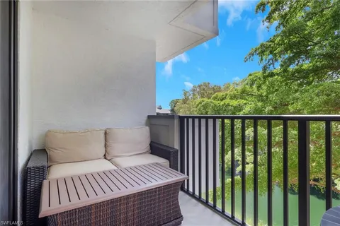 a balcony with wooden floor and outdoor seating