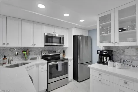 a kitchen with a sink stainless steel appliances and cabinets
