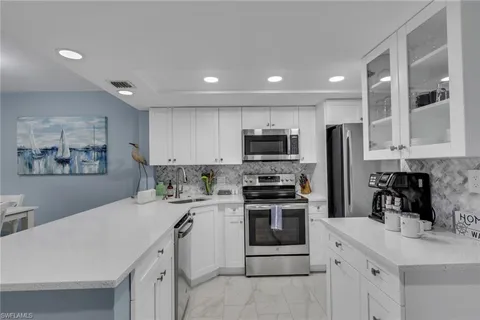 a kitchen with stainless steel appliances a stove sink microwave and cabinets
