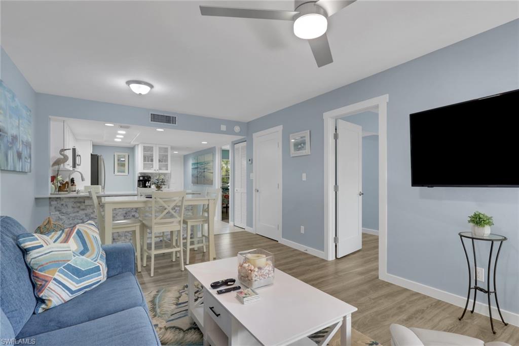 600 Neapolitan Way, Unit 357 Naples, FL 34103 - Photo 8 of 25 a living room with furniture and a flat screen tv