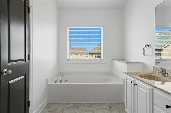 a white bath tub sitting next to a white sink
