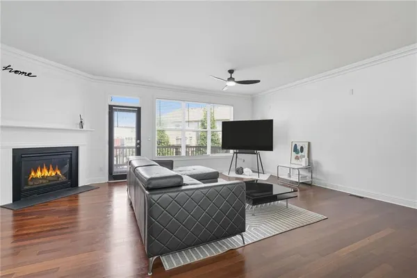 a living room with furniture a fireplace and a flat screen tv