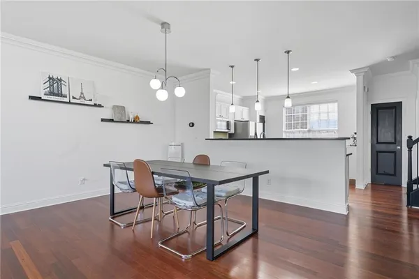 a view of a dining room with furniture and wooden floor