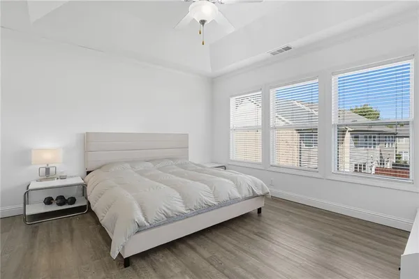 a large bed sitting in a bedroom next to a window