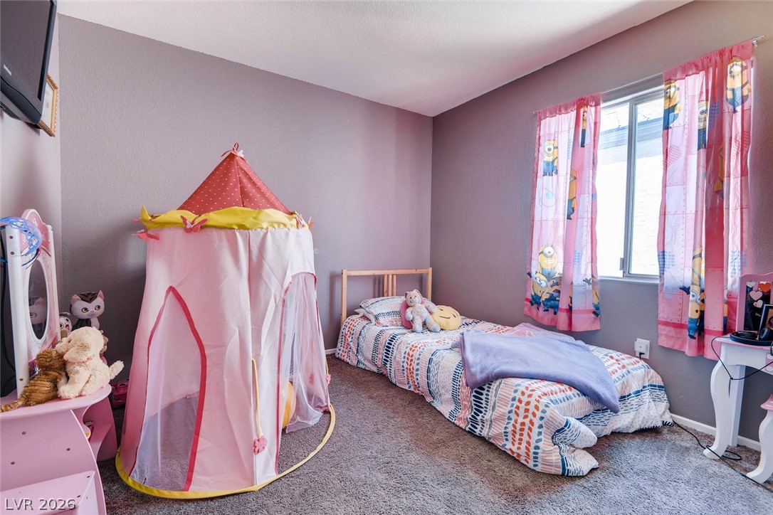 10451 Processor Court Las Vegas, NV 89129 - Photo 21 of 28 A comfortable bedroom, ready for dreams and play, awaits its next occupant.