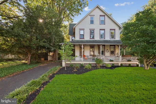 a front view of a house with a yard porch and sitting area