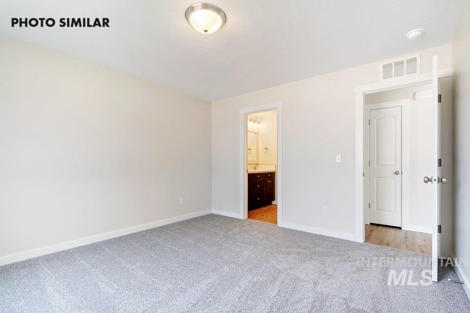 1708 Rapid Road Emmett, ID 83617 - Photo 26 of 33 Carpeted interior space featuring neutral wall tones, a flush-mount ceiling light, and white trim