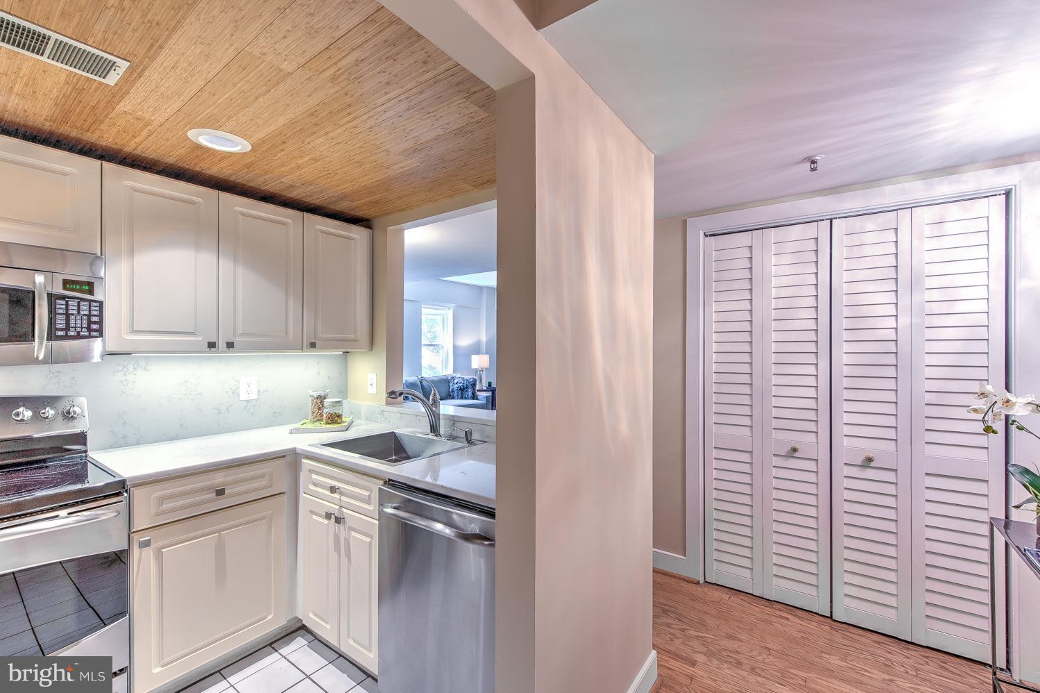 1727 R Street Northwest, Unit 202 Washington, DC 20009 - Photo 2 of 24 a kitchen with a sink cabinets and appliances