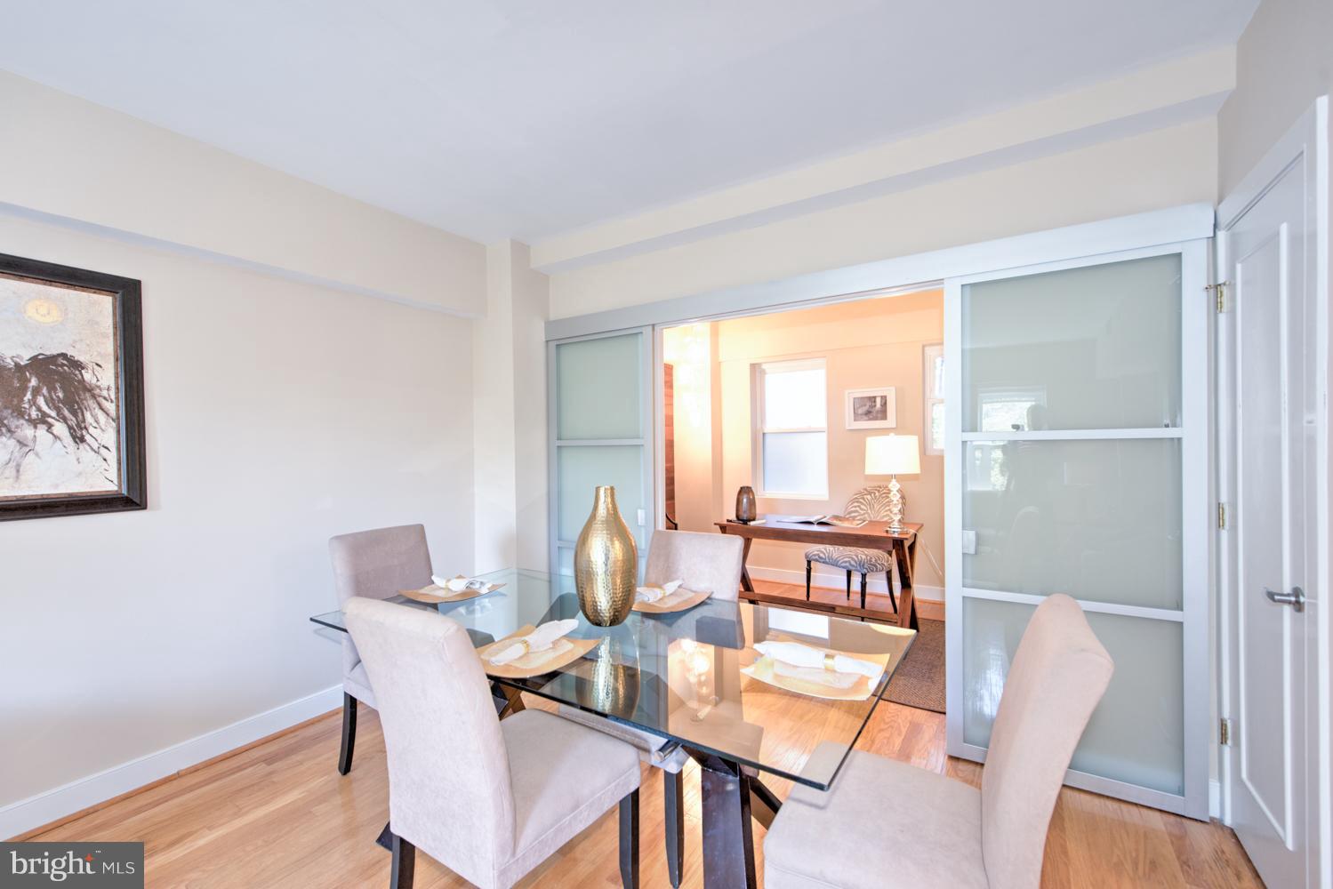 1727 R Street Northwest, Unit 202 Washington, DC 20009 - Photo 12 of 24 a dining room with furniture and a floor to ceiling window
