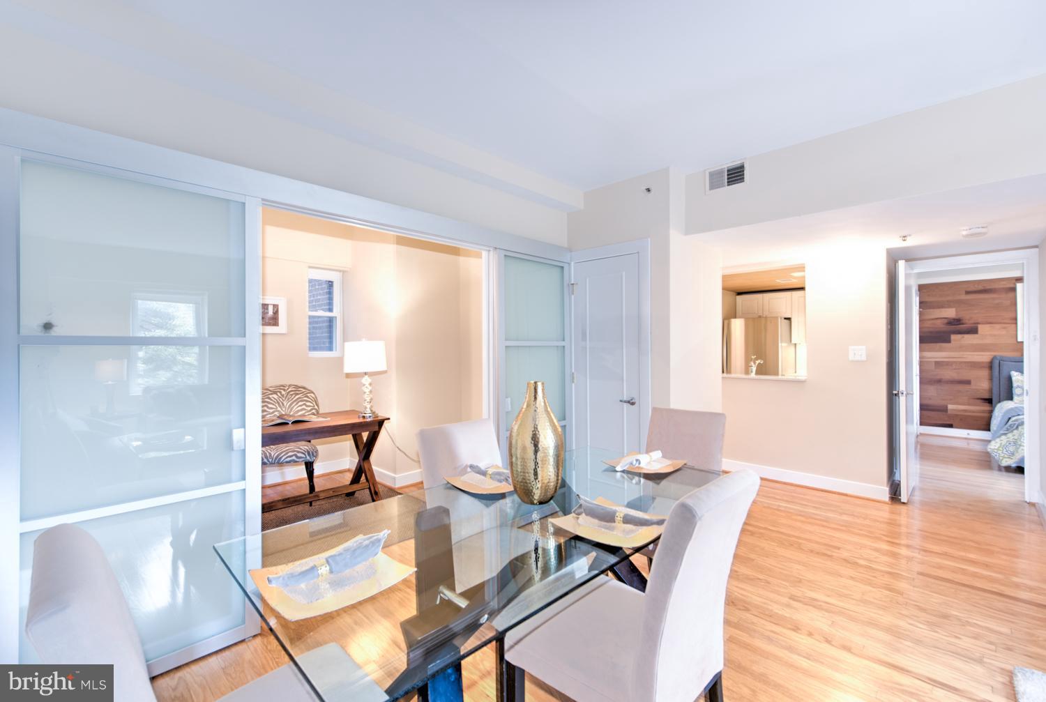 1727 R Street Northwest, Unit 202 Washington, DC 20009 - Photo 13 of 24 a living room with dining room and wooden floor