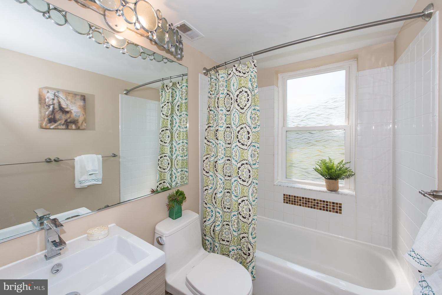 1727 R Street Northwest, Unit 202 Washington, DC 20009 - Photo 21 of 24 a bathroom with a bathtub a sink and a shower