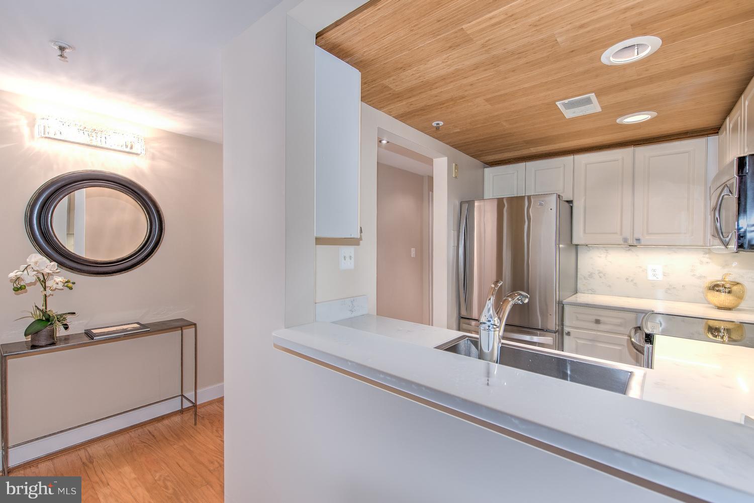 1727 R Street Northwest, Unit 202 Washington, DC 20009 - Photo 5 of 24 a view of a kitchen with a sink and a refrigerator
