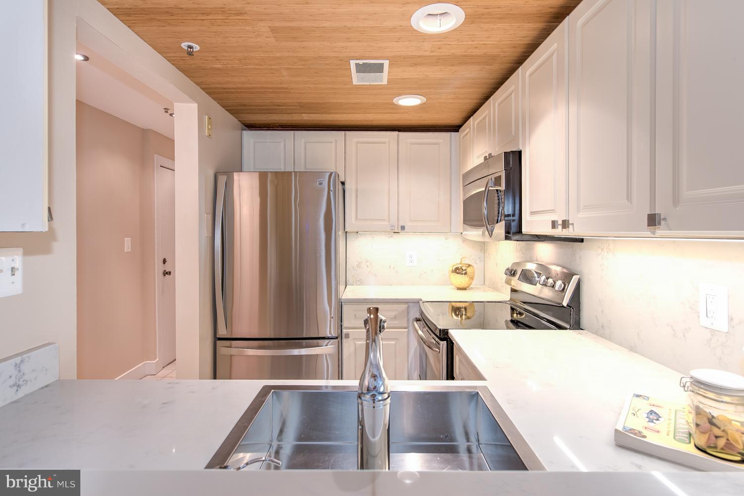 1727 R Street Northwest, Unit 202 Washington, DC 20009 - Photo 6 of 24 a kitchen with stainless steel appliances granite countertop a refrigerator and a sink