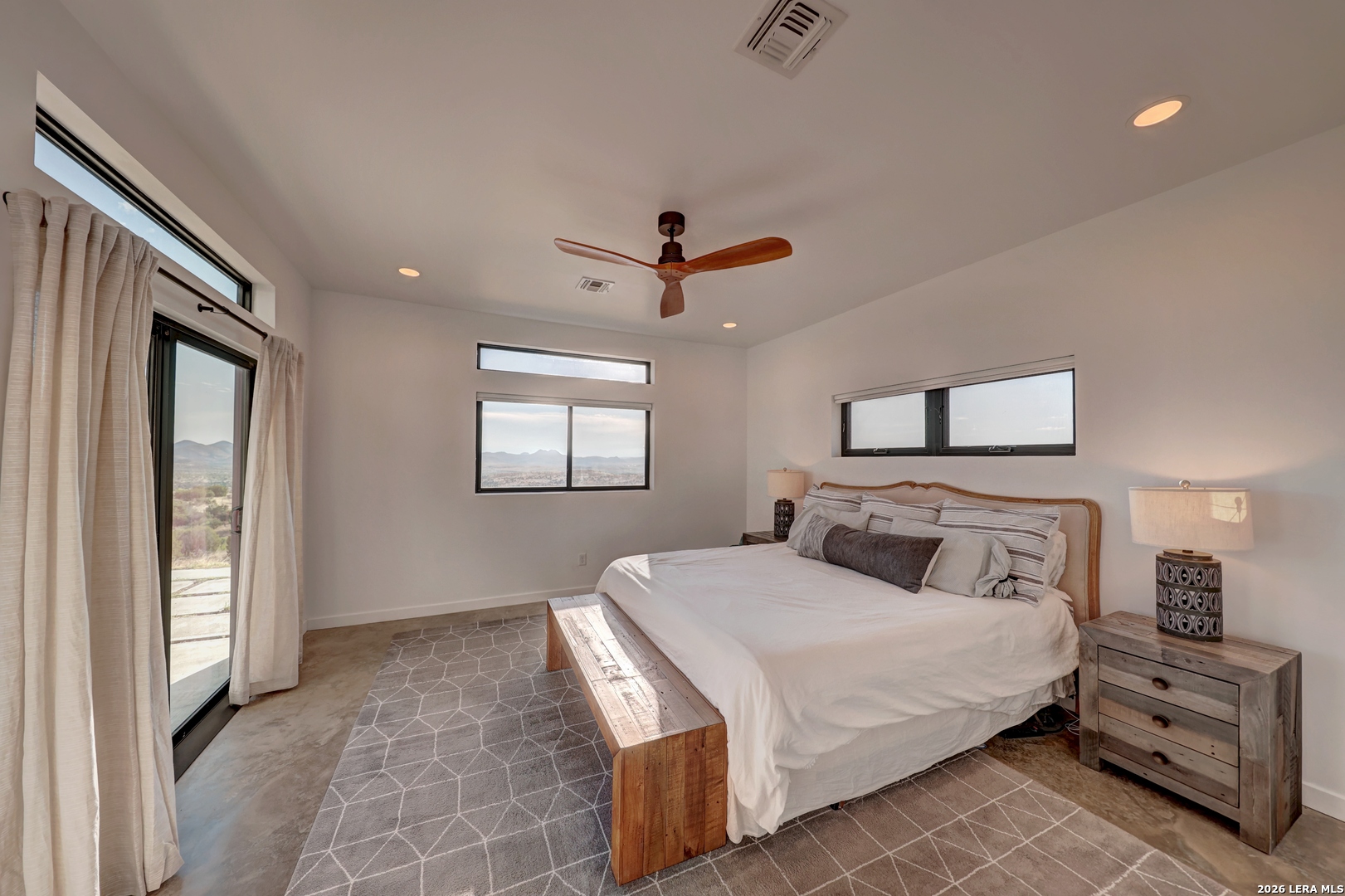 28 Scenic Ridge Road South Alpine, TX 79830 - Photo 15 of 48 a bedroom with a large bed and a chandelier