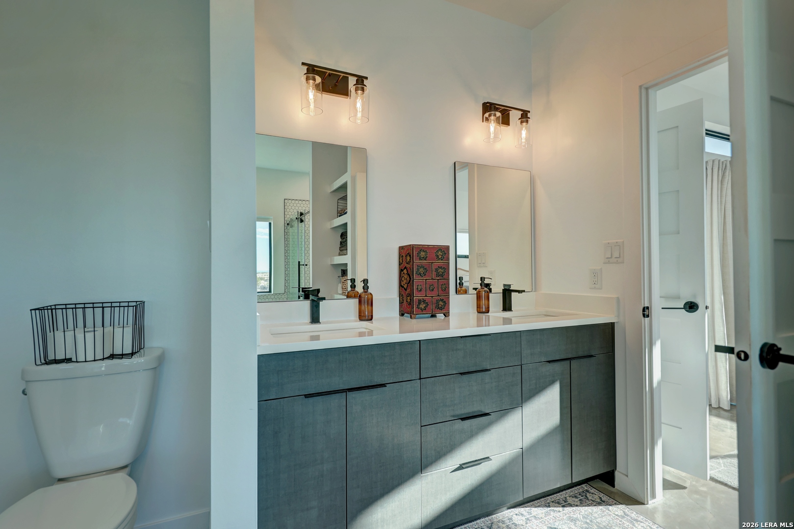 28 Scenic Ridge Road South Alpine, TX 79830 - Photo 19 of 48 a bathroom with a toilet a sink and mirror