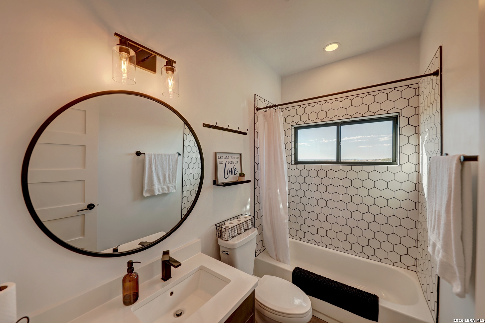 28 Scenic Ridge Road South Alpine, TX 79830 - Photo 22 of 48 a bathroom with a sink a mirror a toilet and shower