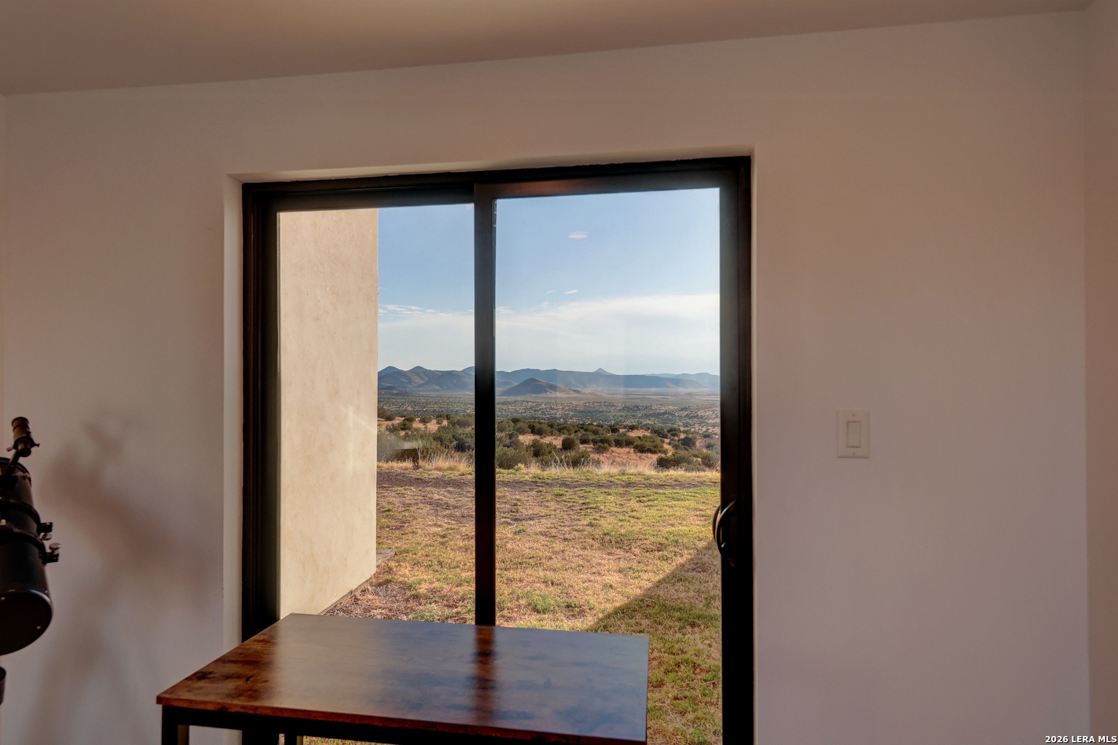 28 Scenic Ridge Road South Alpine, TX 79830 - Photo 32 of 48 a view of a room with a large window and wooden floor