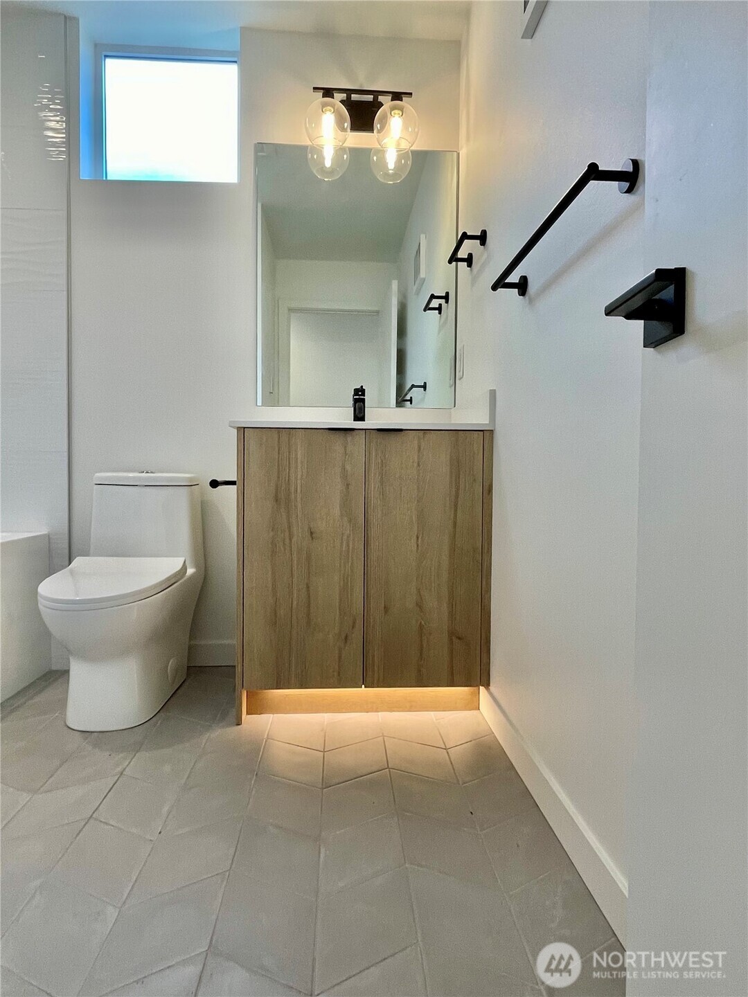 3307 Wetmore Avenue South, Unit A Seattle, WA 98144 - Photo 11 of 24 a bathroom with a toilet a sink and mirror