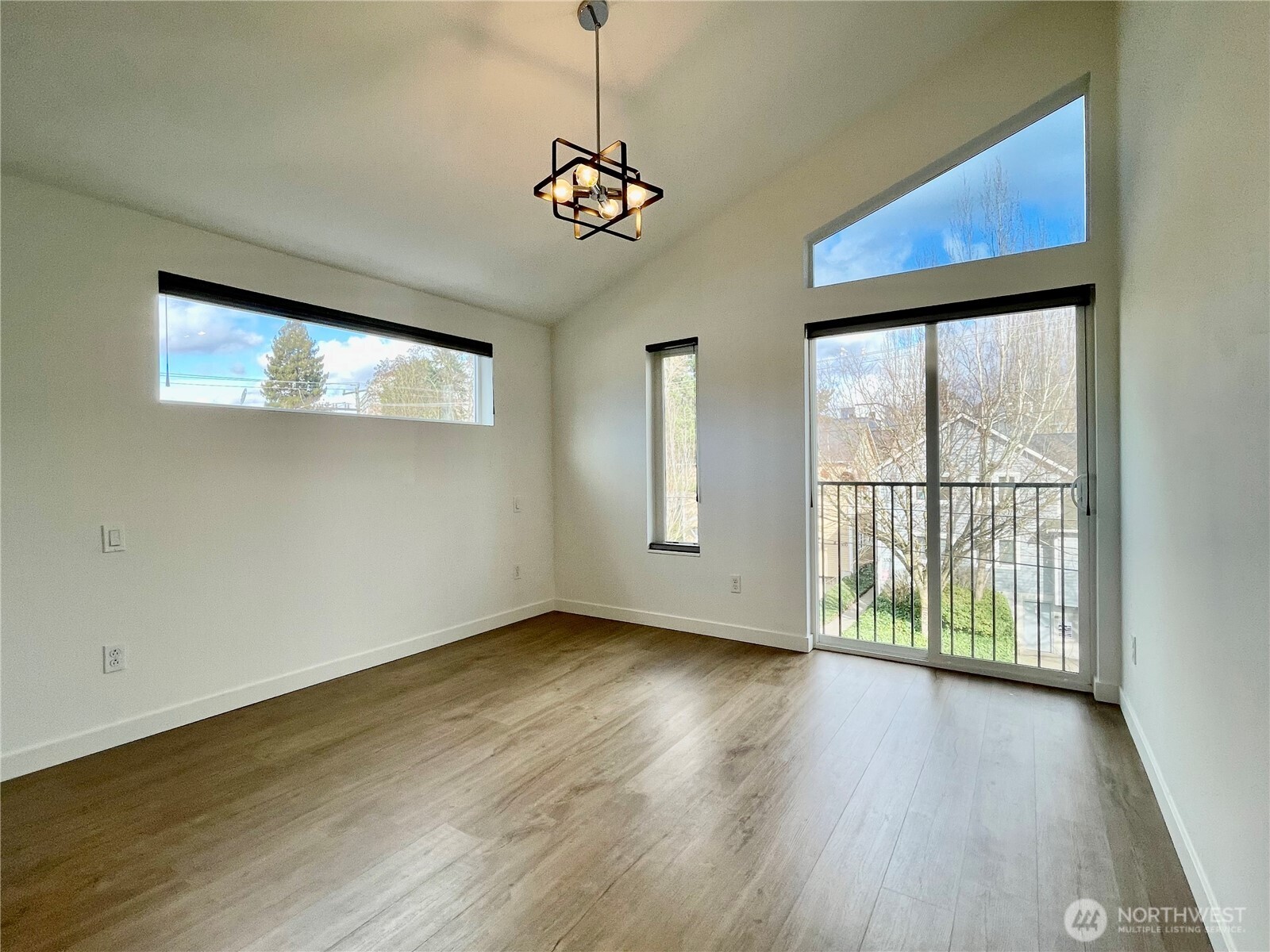 3307 Wetmore Avenue South, Unit A Seattle, WA 98144 - Photo 17 of 24 a view of an empty room with wooden floor and a window