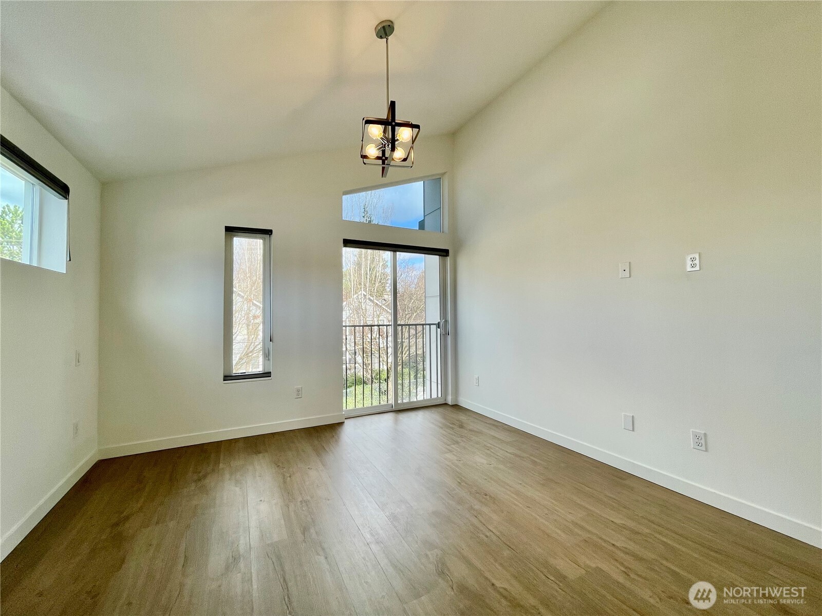 3307 Wetmore Avenue South, Unit A Seattle, WA 98144 - Photo 18 of 24 a view of an empty room with wooden floor and a window