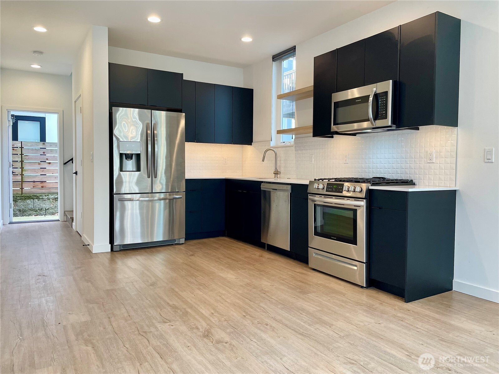 3307 Wetmore Avenue South, Unit A Seattle, WA 98144 - Photo 5 of 24 a kitchen with stainless steel appliances wooden cabinets and granite counter tops