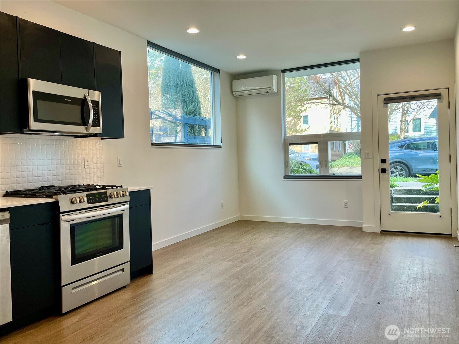3307 Wetmore Avenue South, Unit A Seattle, WA 98144 - Photo 6 of 24 a view of a livingroom with wooden floor and a fireplace