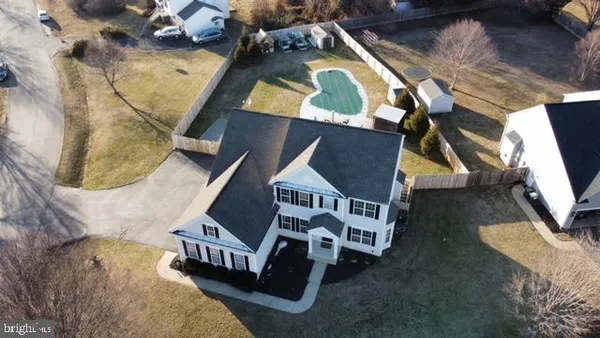 an aerial view of a house with a yard basket ball court and outdoor seating