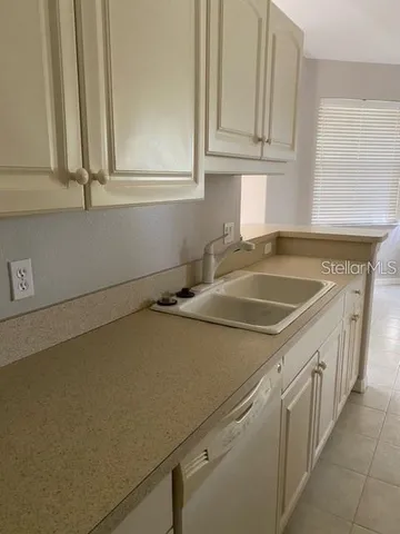 a kitchen with a sink and cabinets