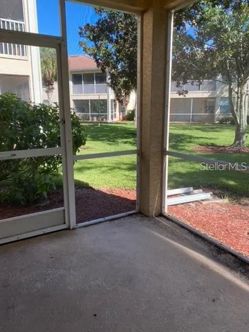 a view of a house with backyard and trees