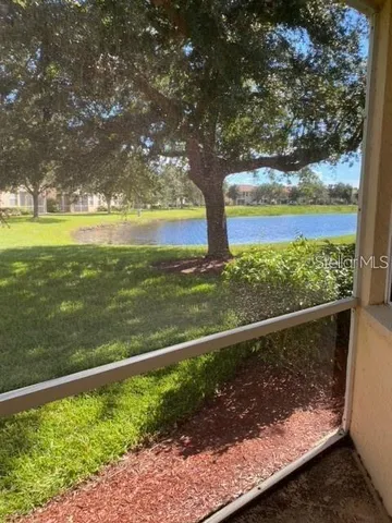 a view of a yard with wooden fence