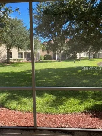 a view of a park with large trees
