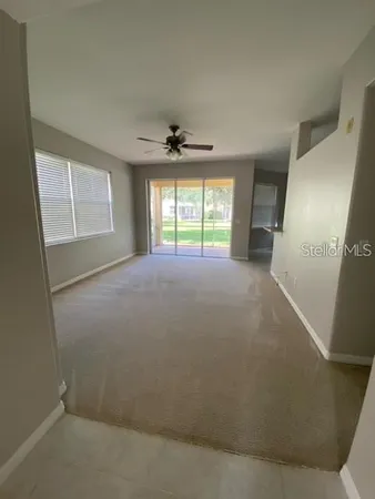 an empty room with windows and cabinet