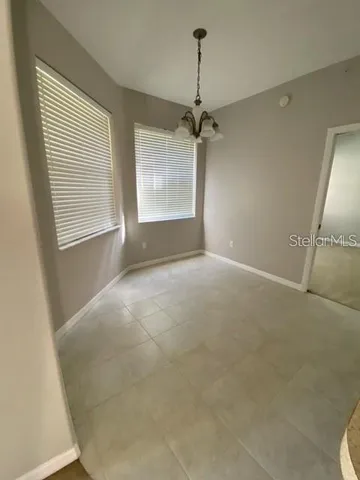 a view of a livingroom with a ceiling fan and window