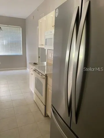 a white refrigerator freezer and a dishwasher in a kitchen