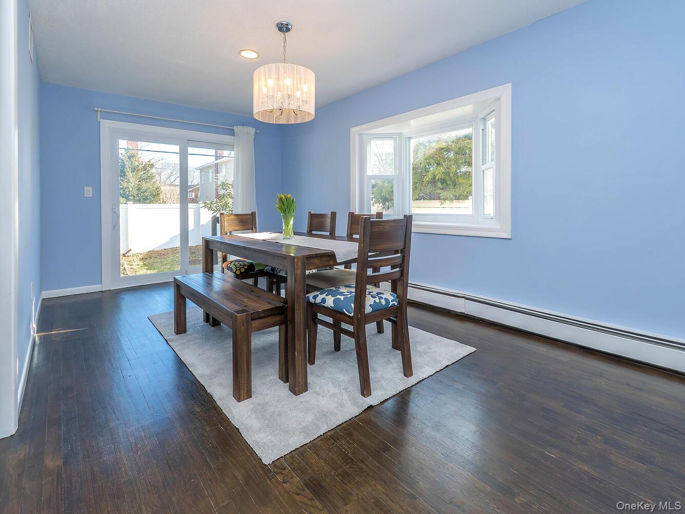 127 Cow Neck Road Port Washington, NY 11050 - Photo 13 of 31 a view of a dining room with furniture window and wooden floor