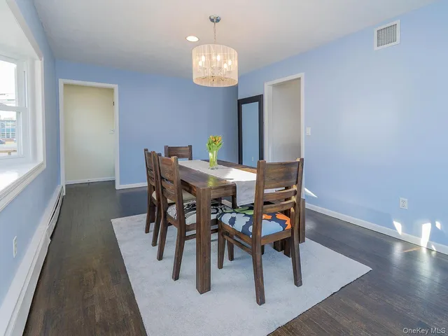 a view of a dining room with furniture and chandelier