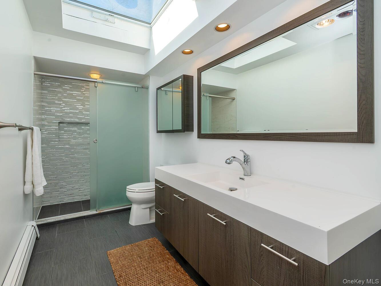 127 Cow Neck Road Port Washington, NY 11050 - Photo 18 of 31 a bathroom with a sink and a mirror