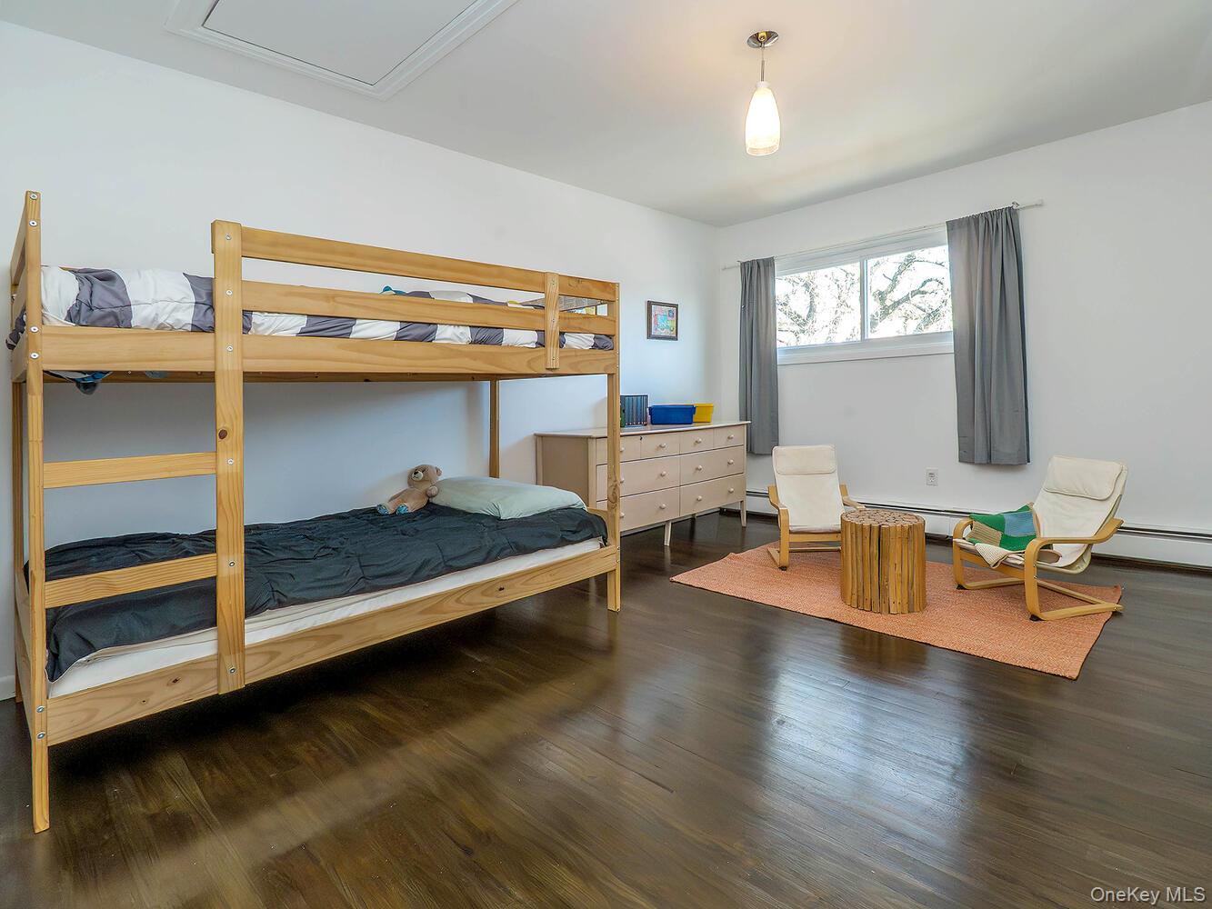 127 Cow Neck Road Port Washington, NY 11050 - Photo 19 of 31 a living room with furniture a window and wooden floors