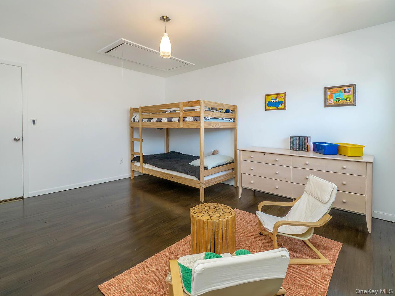 127 Cow Neck Road Port Washington, NY 11050 - Photo 20 of 31 a bedroom with a bed and a desk