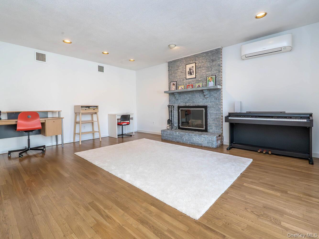127 Cow Neck Road Port Washington, NY 11050 - Photo 24 of 31 a living room with furniture and a fireplace