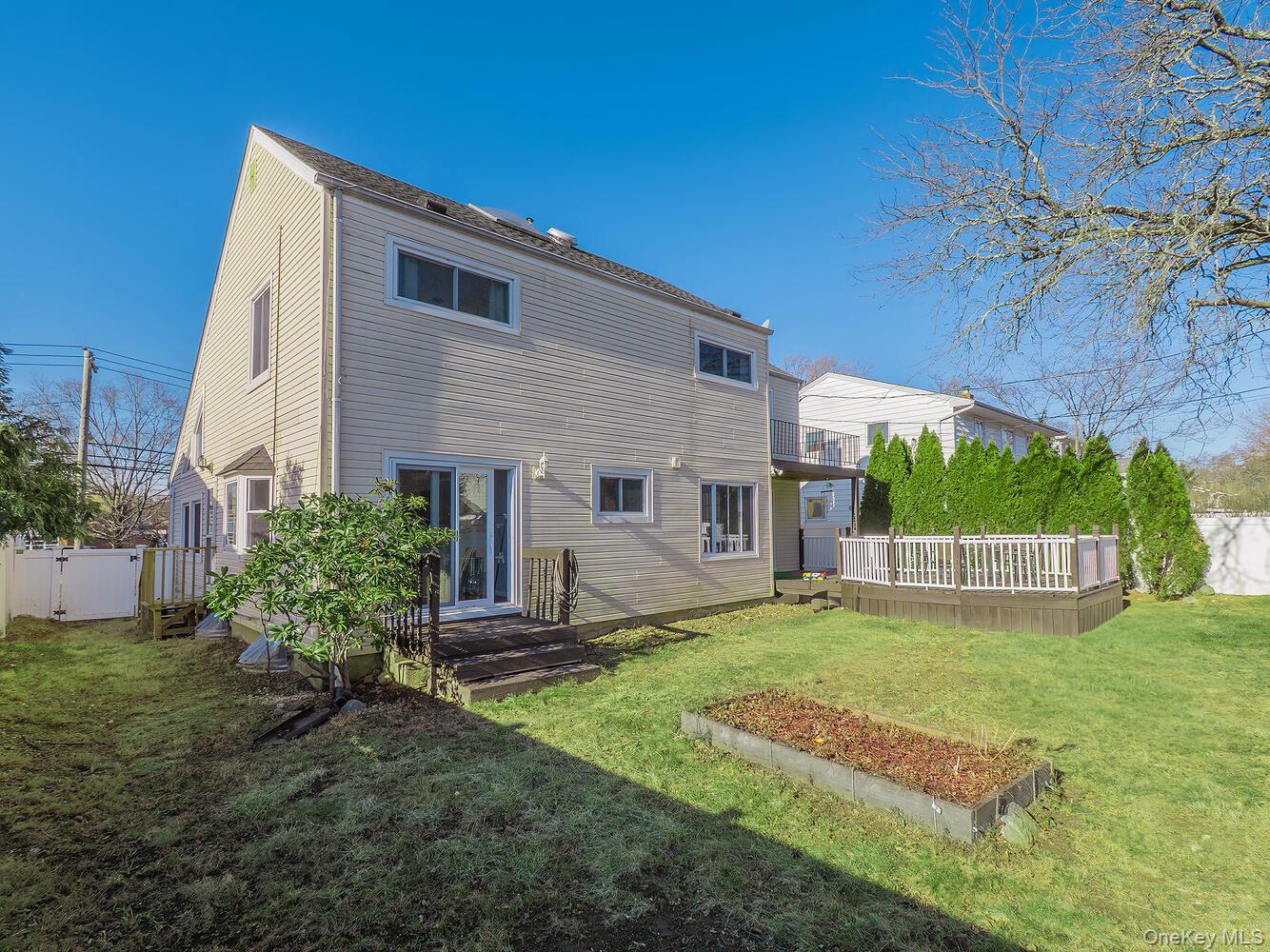 127 Cow Neck Road Port Washington, NY 11050 - Photo 28 of 31 a view of a house with a yard