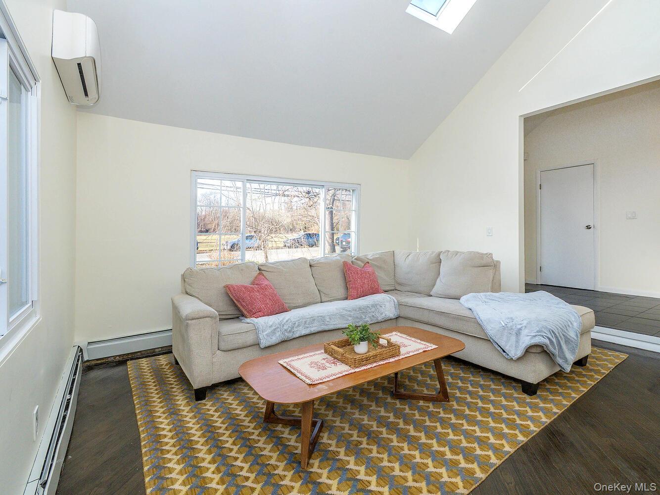 127 Cow Neck Road Port Washington, NY 11050 - Photo 6 of 31 a living room with furniture and wooden floor