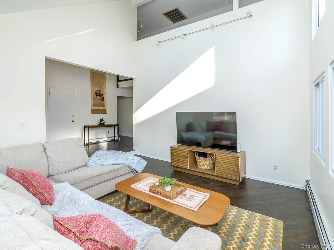 127 Cow Neck Road Port Washington, NY 11050 - Photo 7 of 31 a living room with furniture and a flat screen tv