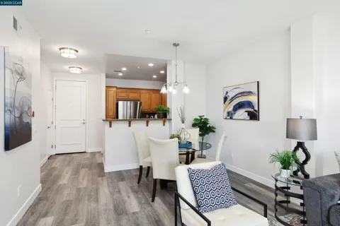 a view of a dining room with furniture wooden floor and a chandelier