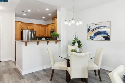 a kitchen with stainless steel appliances granite countertop a refrigerator sink and stove