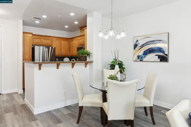a kitchen with stainless steel appliances granite countertop a refrigerator sink and stove