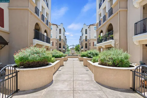 a front view of a building with outdoor seating and plants