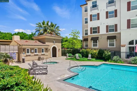 a view of swimming pool with outdoor seating and plants
