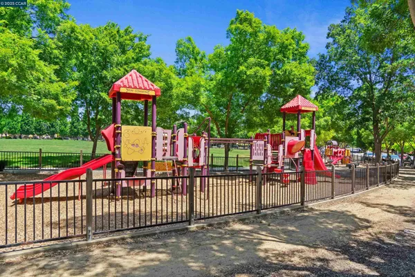 a view of a street with a houses in the background