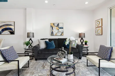 a living room with furniture fireplace and wooden floor